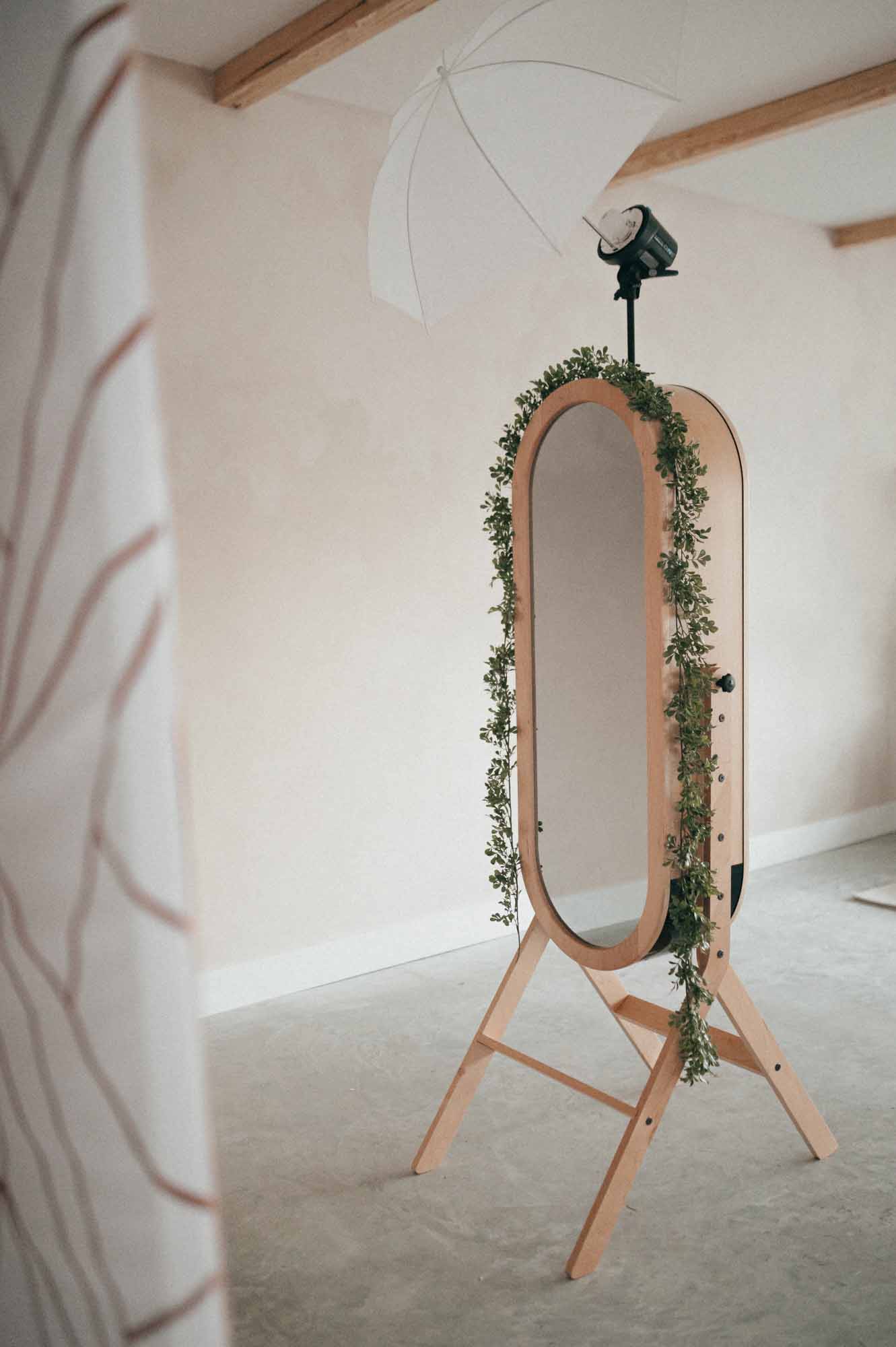 A mirror with a garland hanging from it